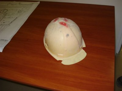 Helmet taken off worker during workplace inspection