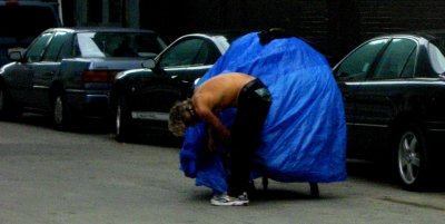 Blue covered cart by cars