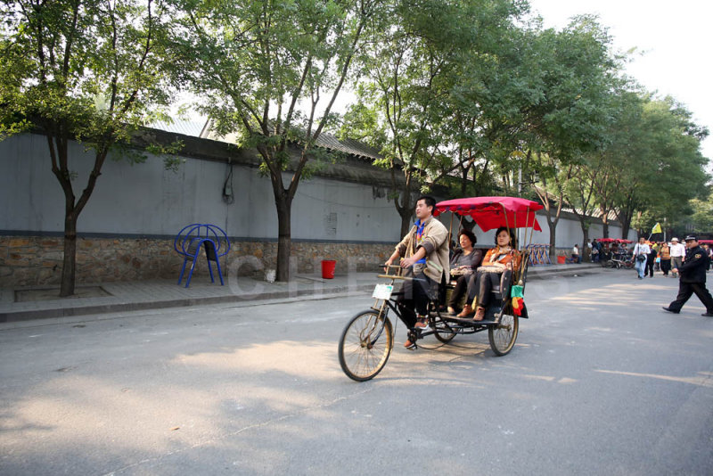 Visitors take a trishaw ride