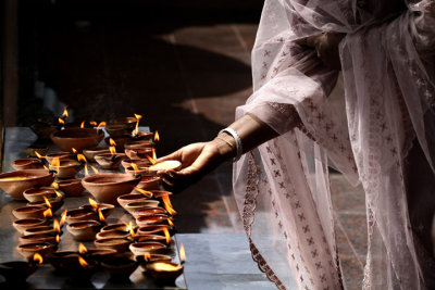 Lighting oil lamps, Batu Caves, Malaysia