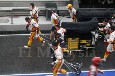 Pit crew running to the grid