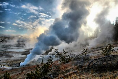 Steaming, bubbling, geyser landscape at sunrise