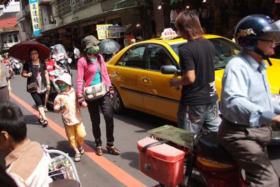 vehicles and pedestrians all on road