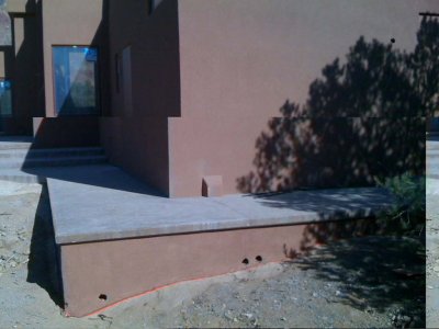 Finished stucco below walkway