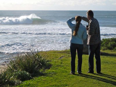 Jess and Adam admire the large waves