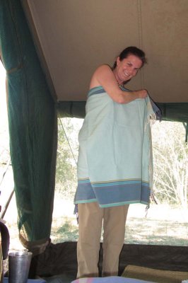 Cyn dresses in her kikoi at bush camp