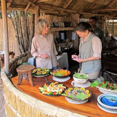 Cyn writes up the menu with Babette, Kuyenda