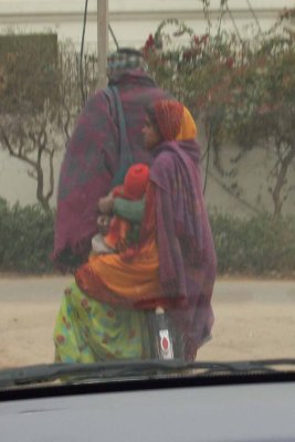 Side-saddle on a bike (carrying baby too)