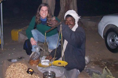 Cyn getting roasted peanuts from a street vendor