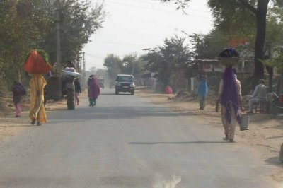 Women with loads along the road
