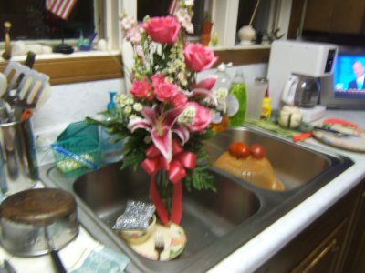Roses and Lilies in kitchen sink 