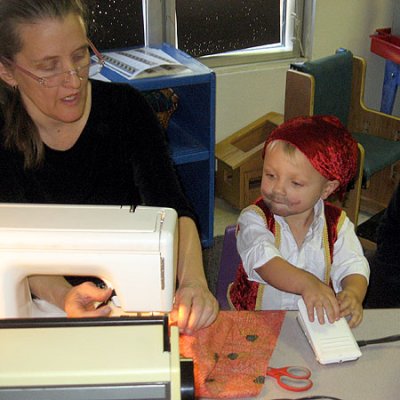 Helping sew his Halloween bag