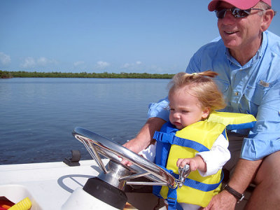Is that a 1-yr-old driving the boat??