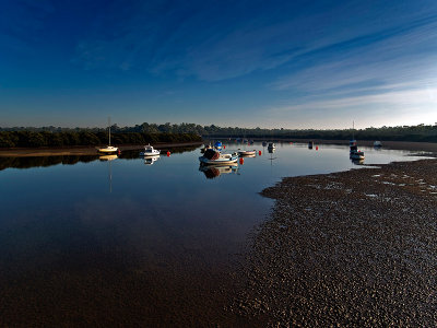 Moored at low tide by Dennis
