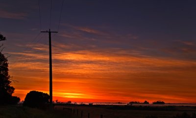 Telephone pole sunrise by Dennis