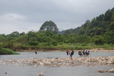 Crossing the swift Magoh in group.
