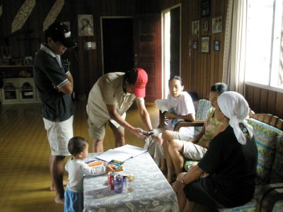 Giving angpow to his girls. 1 of them has a kid.