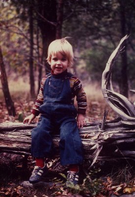 Eric sitting on a fallen tree.