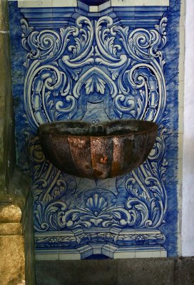 Interior holy water urn and tile background