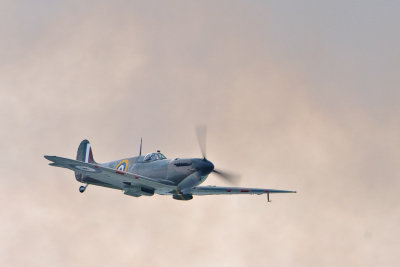 MkII Spitfire flying past ground smoke.jpg
