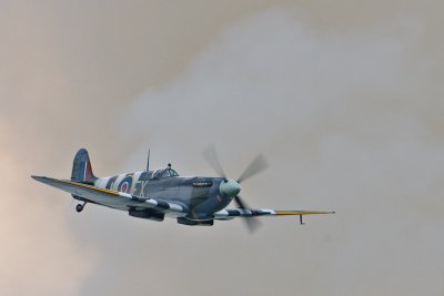 Spitfire flying past grond smoke.jpg