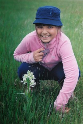 Johanna with the globally threatened western prairie fringed orchid. Tall Grass Prairie Preserve, MB