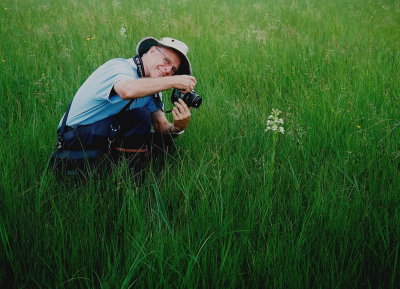Richard Reeves (intrepid orchid guide) photographing Platanthera praeclara. Tall Grass Prarie, MB