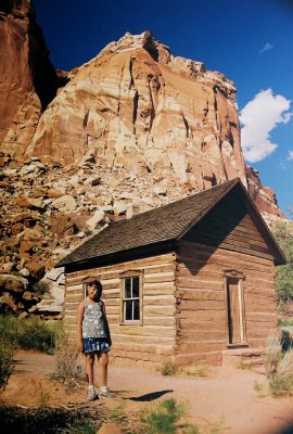 Johanna poses by a restored 19th century Mormon one-room schoolhouse. Fruita, Utah.