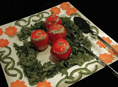 Stuffed tomatoes with carrot and green pepper decoration