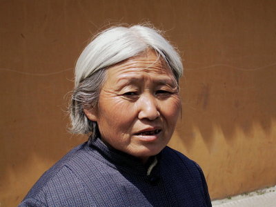 Old woman outside temple