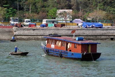 Rowboat and boat in harbor