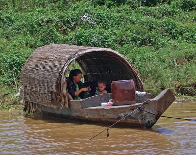 Mother and child in a covered boat
