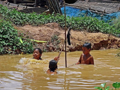 Children playing in a pond