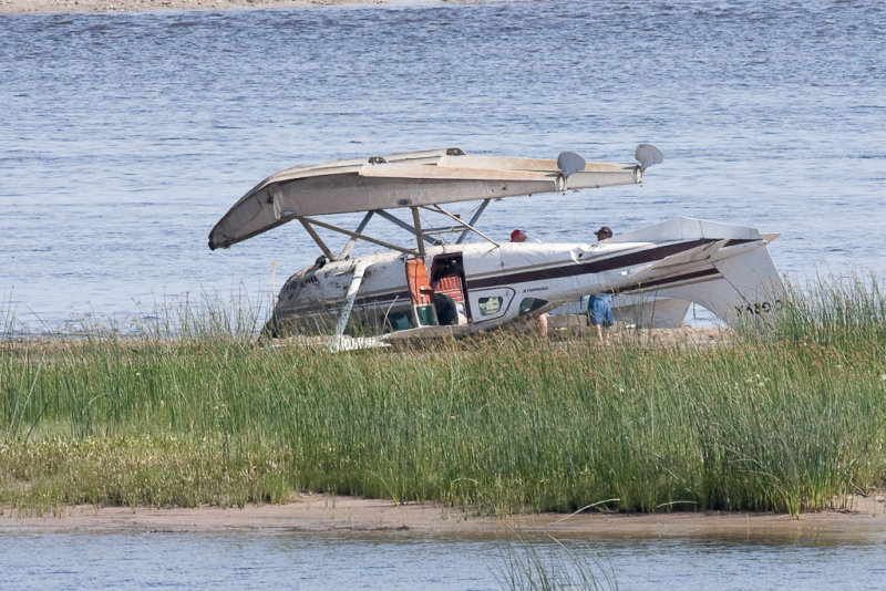 Cessna upside down on sandbar