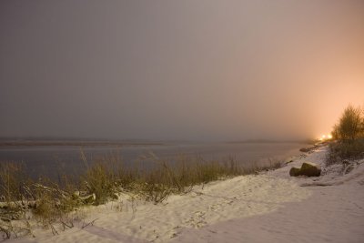 Looking upriver along the shore as fog rolls in at night