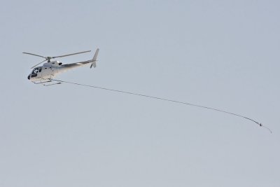 Helicopter returning to Moosonee trailing sling line