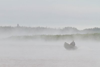 Canoe coming out of the fog