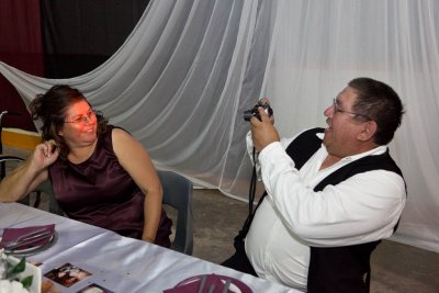 Husband taking picture of wife at head table