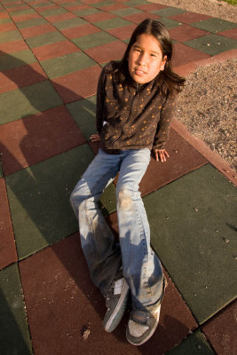 Wide angle shot of girl on soft material in playground