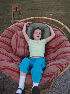 Helen Relaxing in Big Chair at Nearby Garage Sale