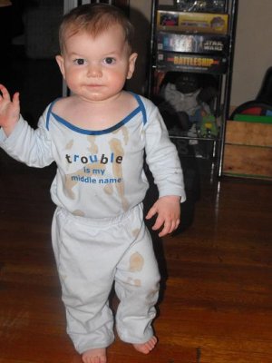 The onesie says it all. It's grape juice, but it looks like he just came from a bar brawl.
