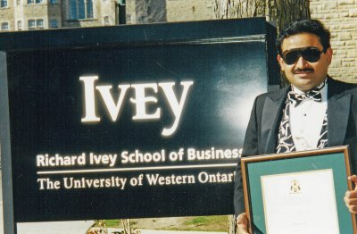 The MBA Graduate with his new found credentials in front of his Alma Mater:-)