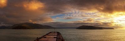 Panorama of bulk carrier approaching Lyttelton Harbour at sunset, Canterbury, New Zealand