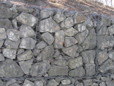 The rocks have to wired together so they are not washed away by the Spring floods.