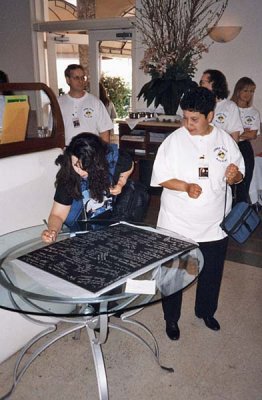 Signing a poster for Gloria