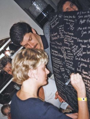 Sheila signs poster held by Donald