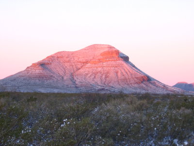 the sunrises washes over desert rocks