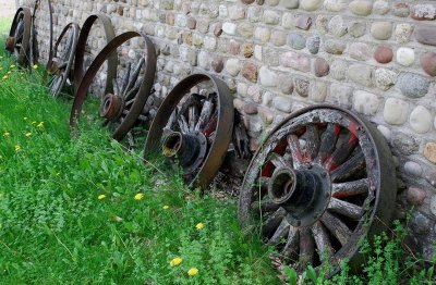 Wagon Wheels On Cobblestone Wall