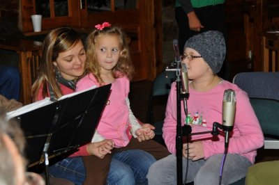 Natalie beautifully sang 7 or 8 Christmas Carols with the help of little sister, Lauren, sitting in Sabrina's lap