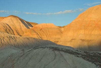 Late afternoon sun lights the badland hilltops